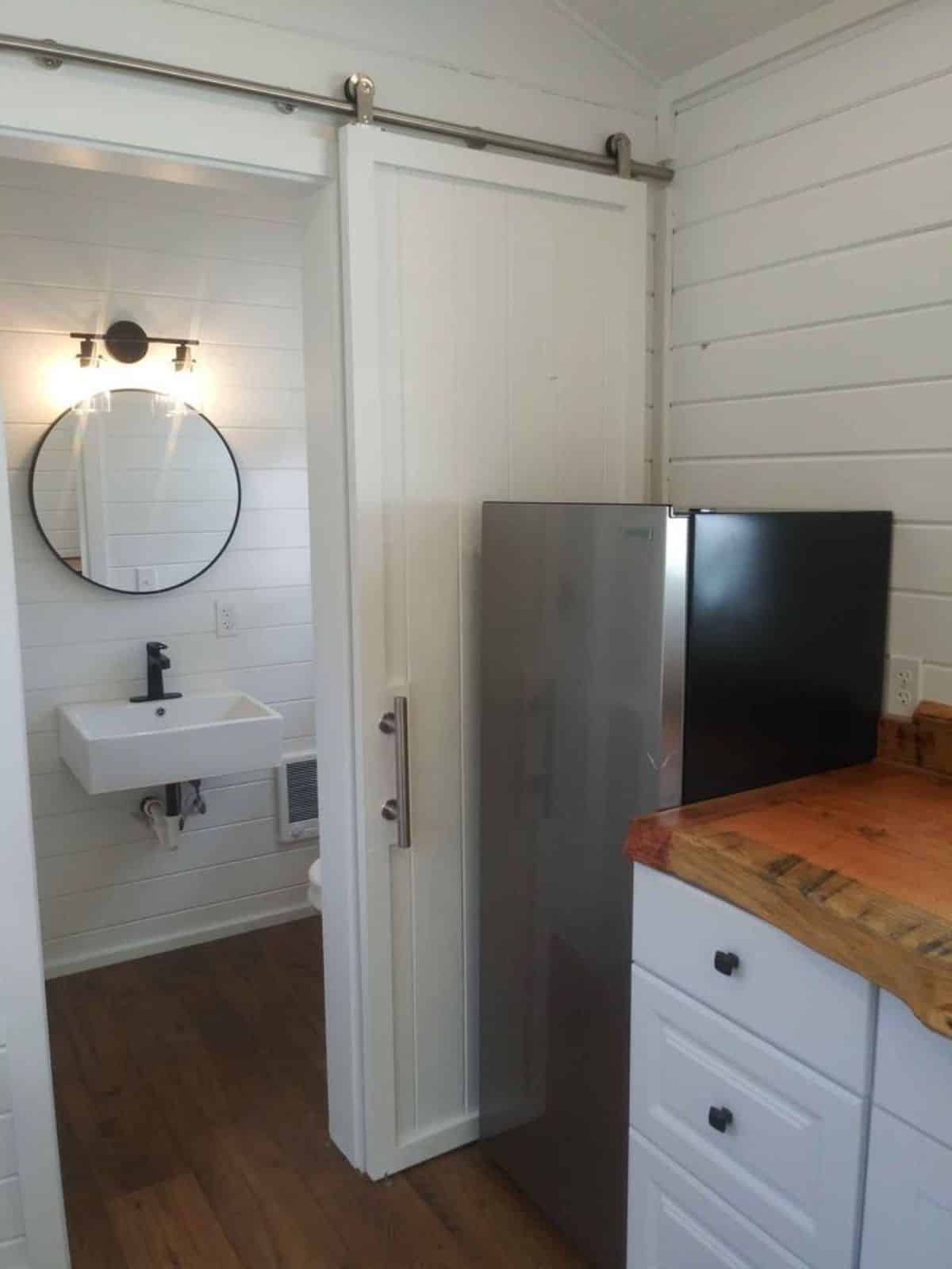 full size refrigerator in kitchen area of 20’ cottage tiny house