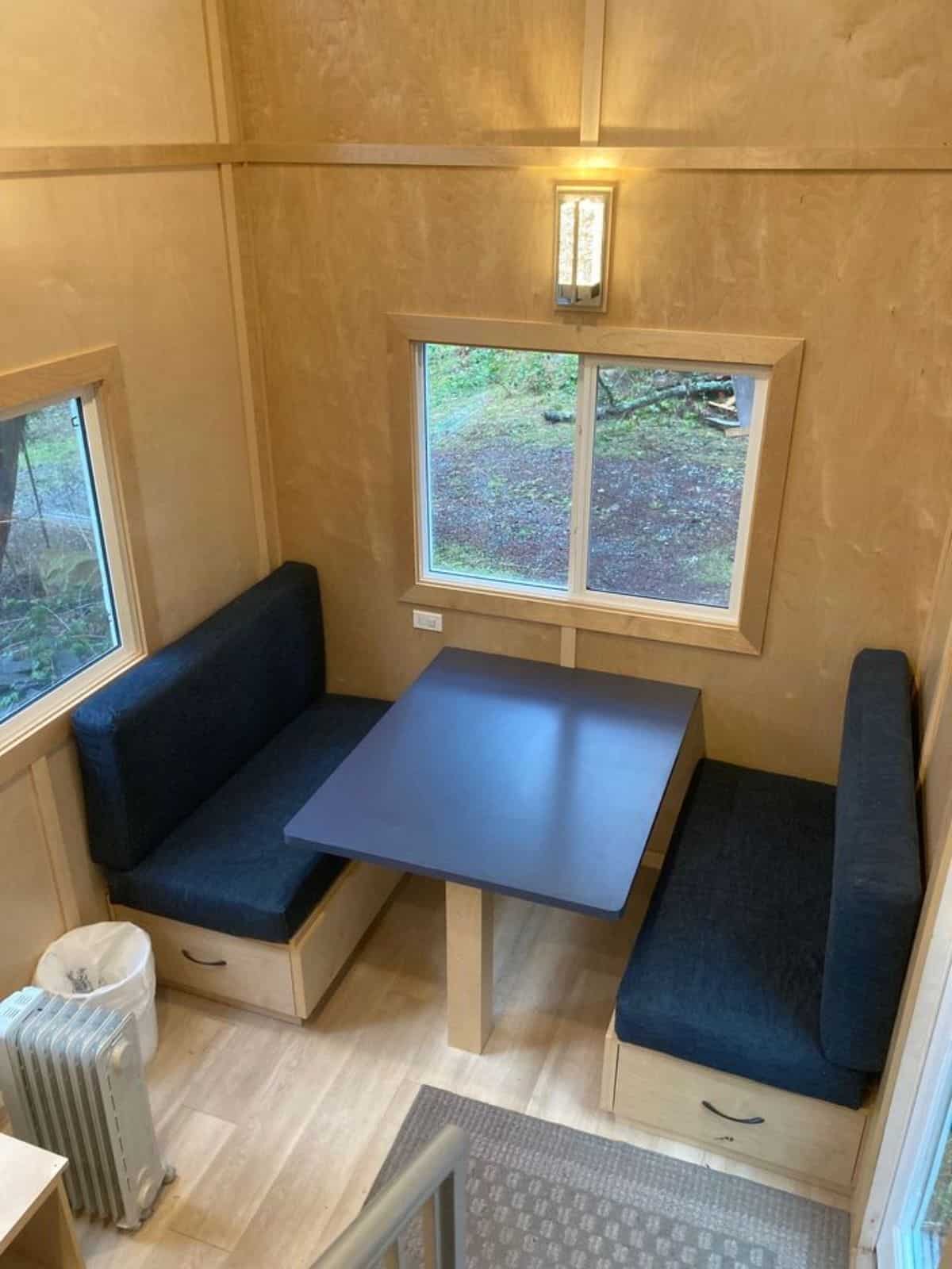 dining table with couch besides the window in living area