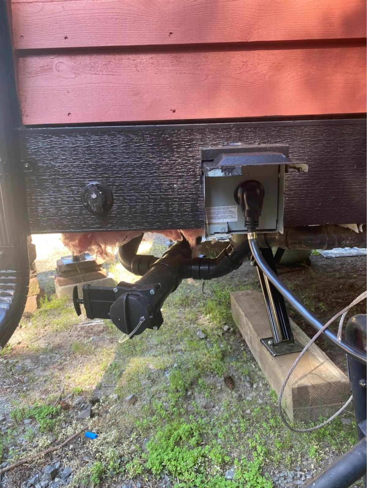 an electric jack at the end outside the insulated tiny home