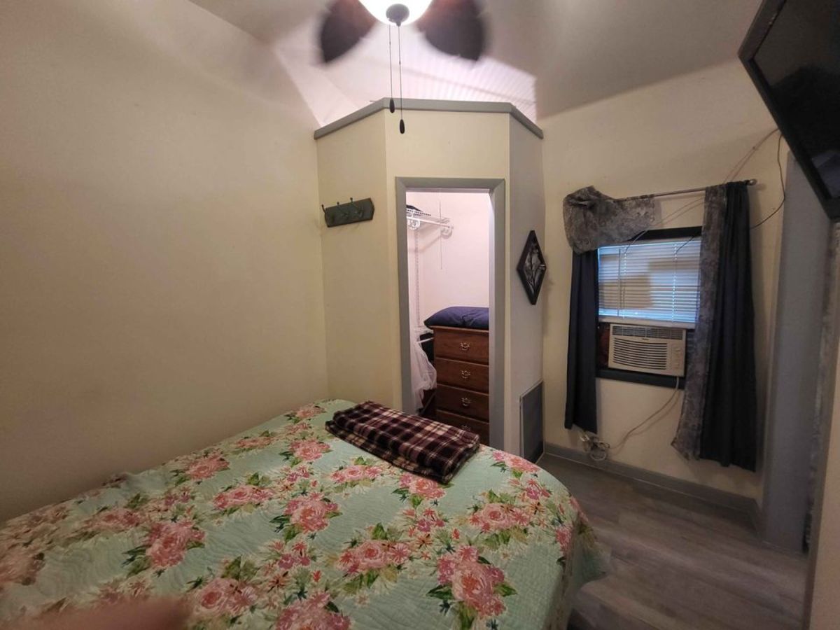 single bed in the bedroom with small small wardrobe and an air condition unit