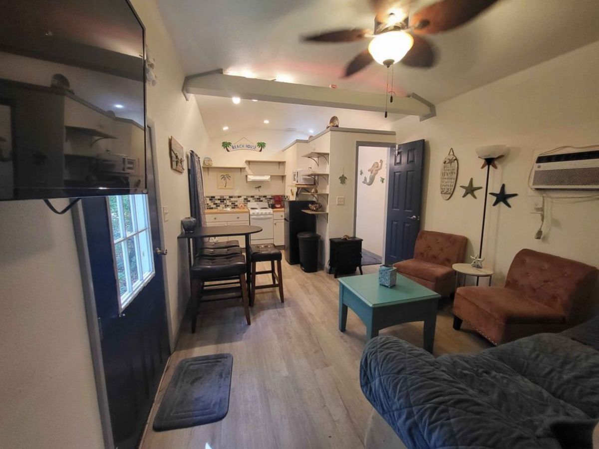full length interiors of spacious tiny house from living room view