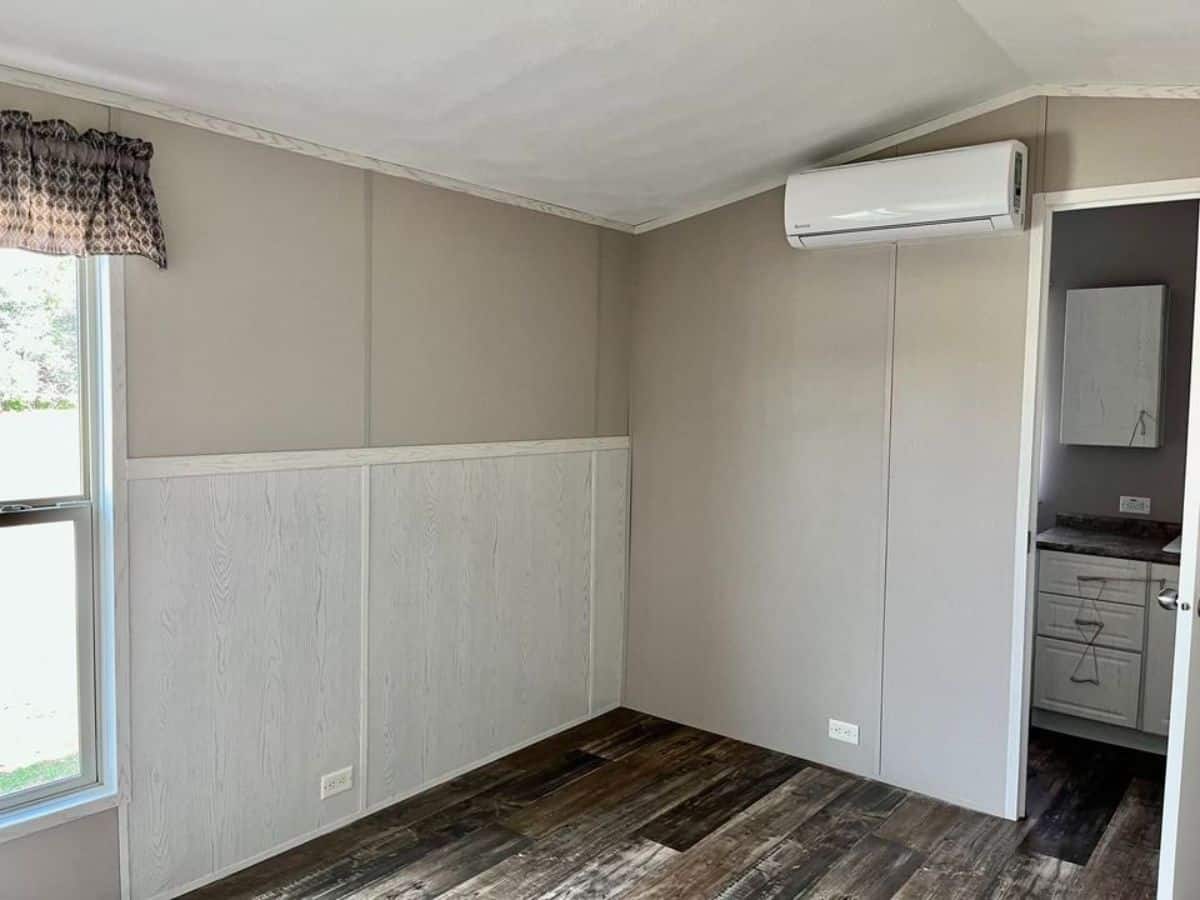 an air condition unit is installed in the living area of beautiful tiny home