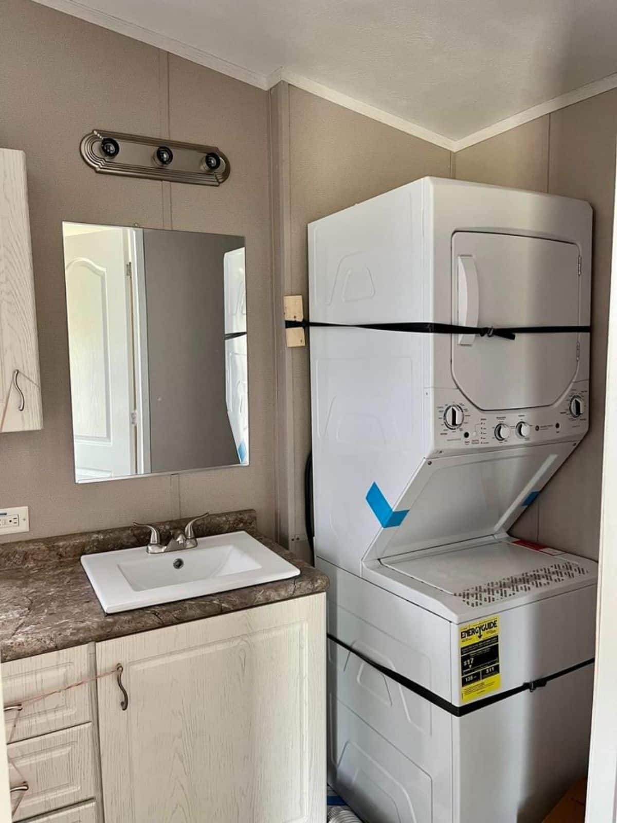 washer dryer combo installed in bathroom of beautiful tiny home