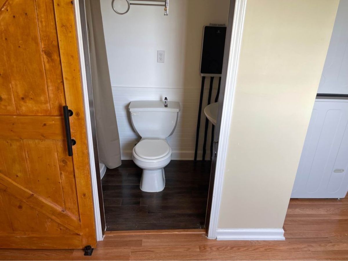 standard toilet in the bathroom of beautiful tiny home