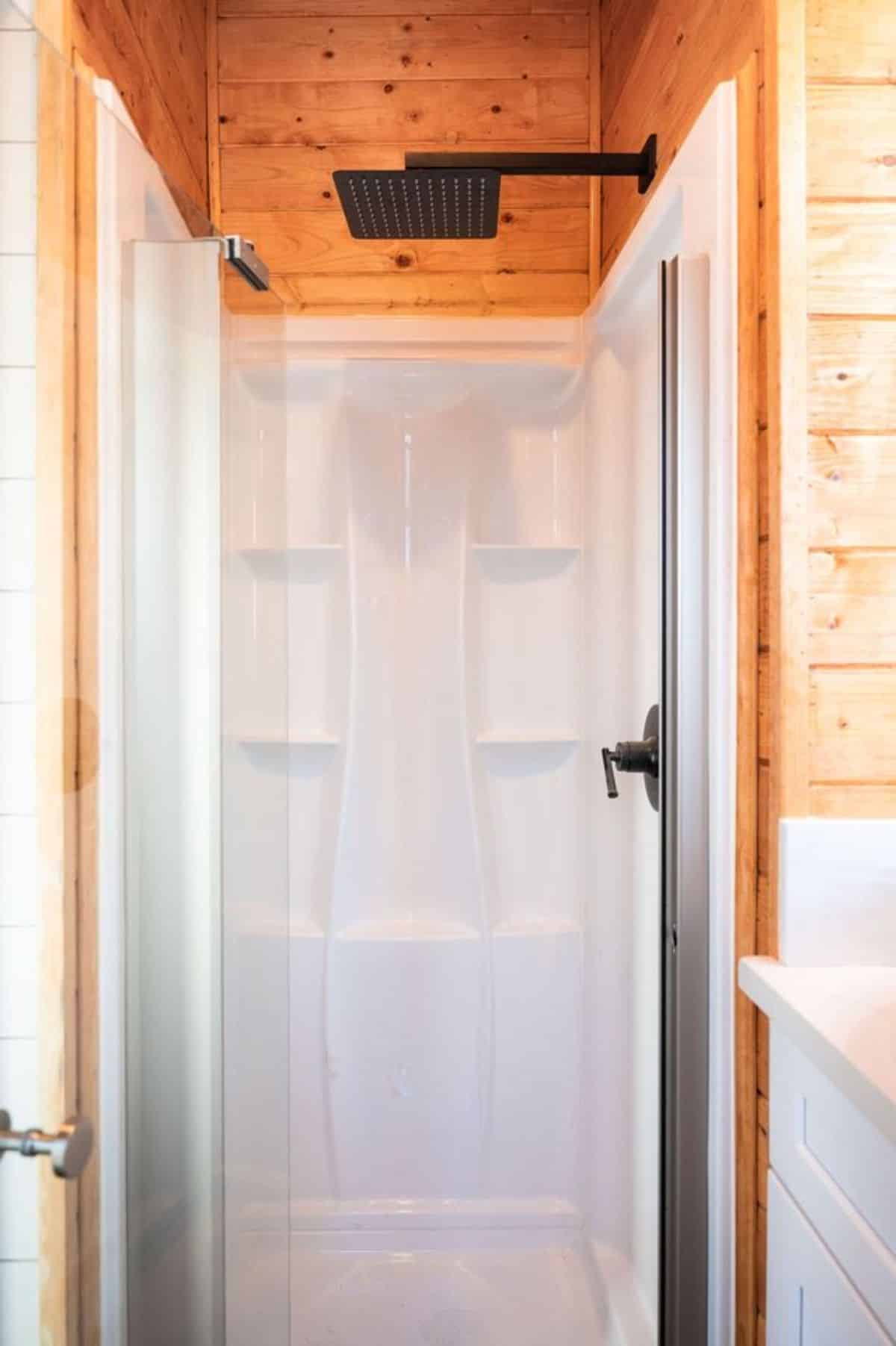 full length shower area in bathroom of brand new tiny home