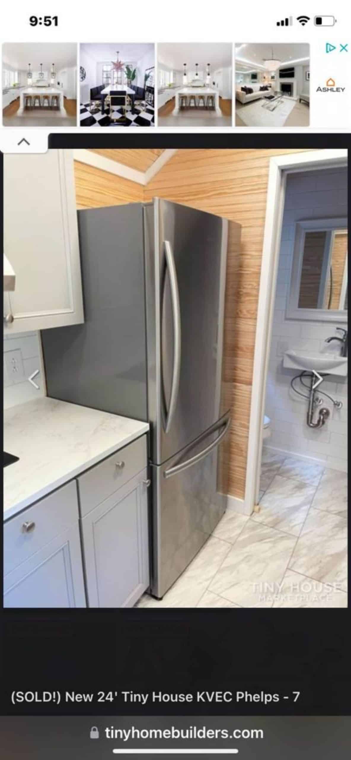double door refrigerator and storage cabinets in kitchen area of cozy tiny home
