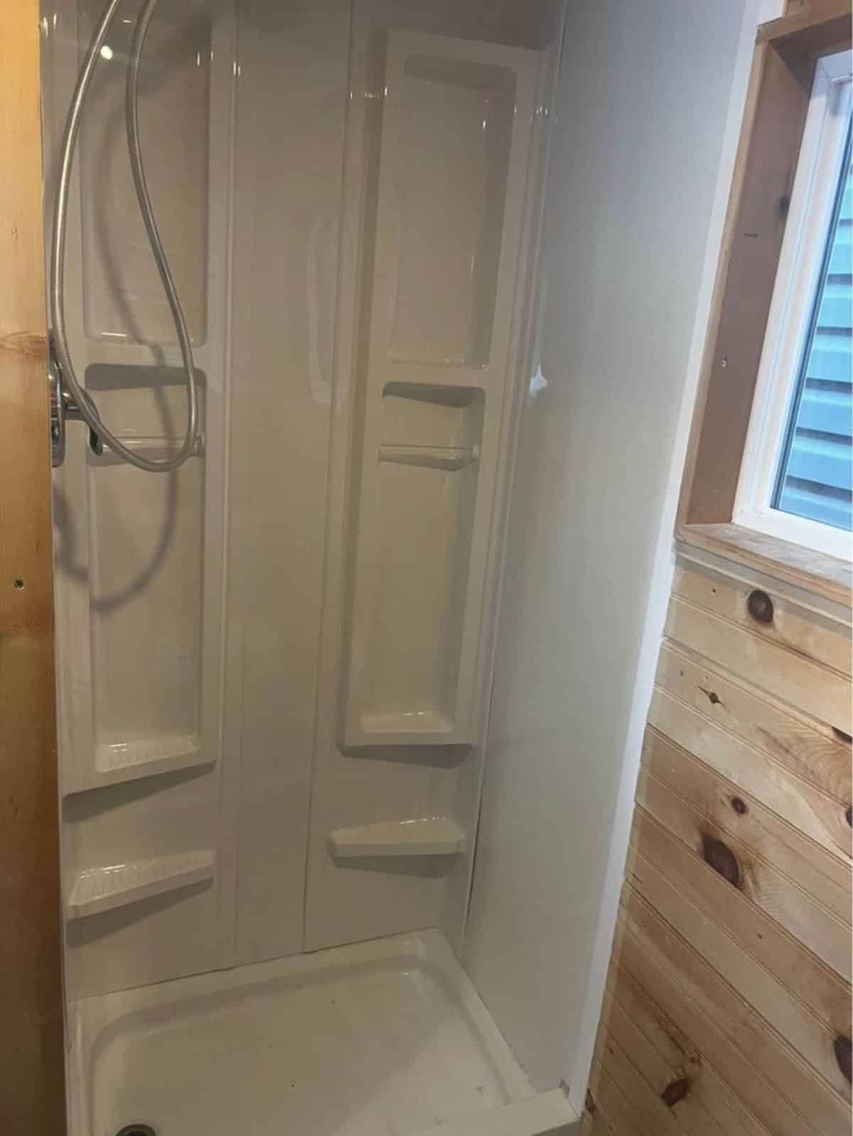 full length shower area in bathroom of custom tiny house