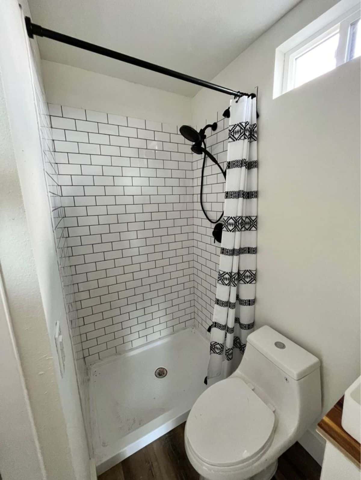 full length shower area in bathroom of shipping container home