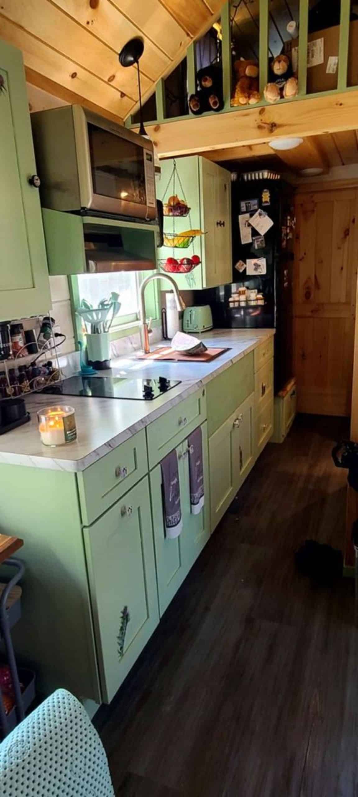 huge countertop with sink and all the appliances in the kitchen of mountain tiny home