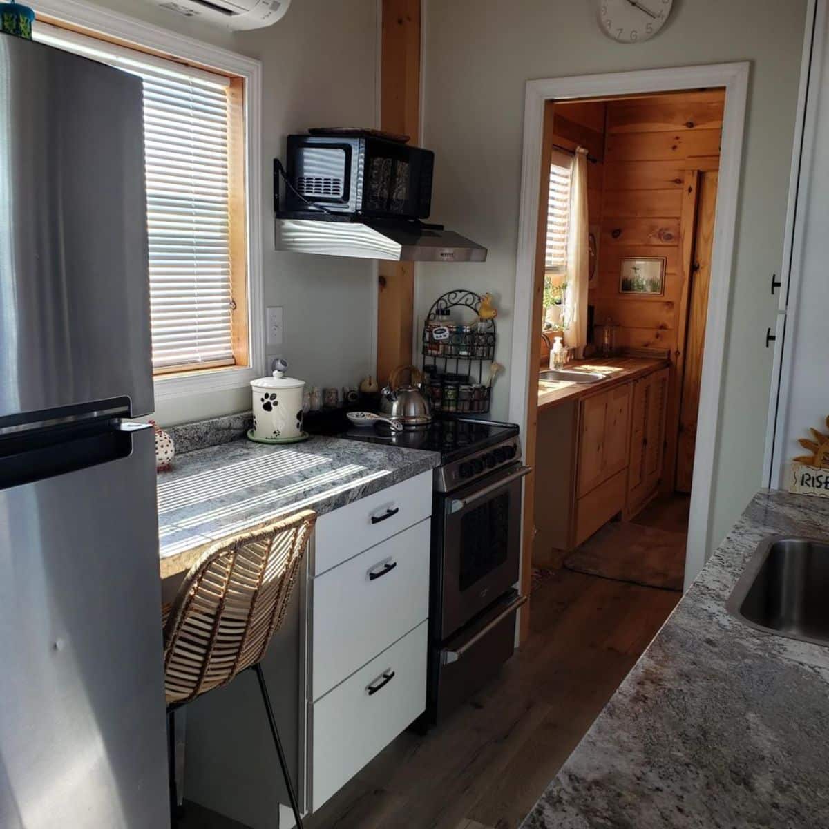 opposite side is double door refrigerator, stove and oven with storage cabinets
