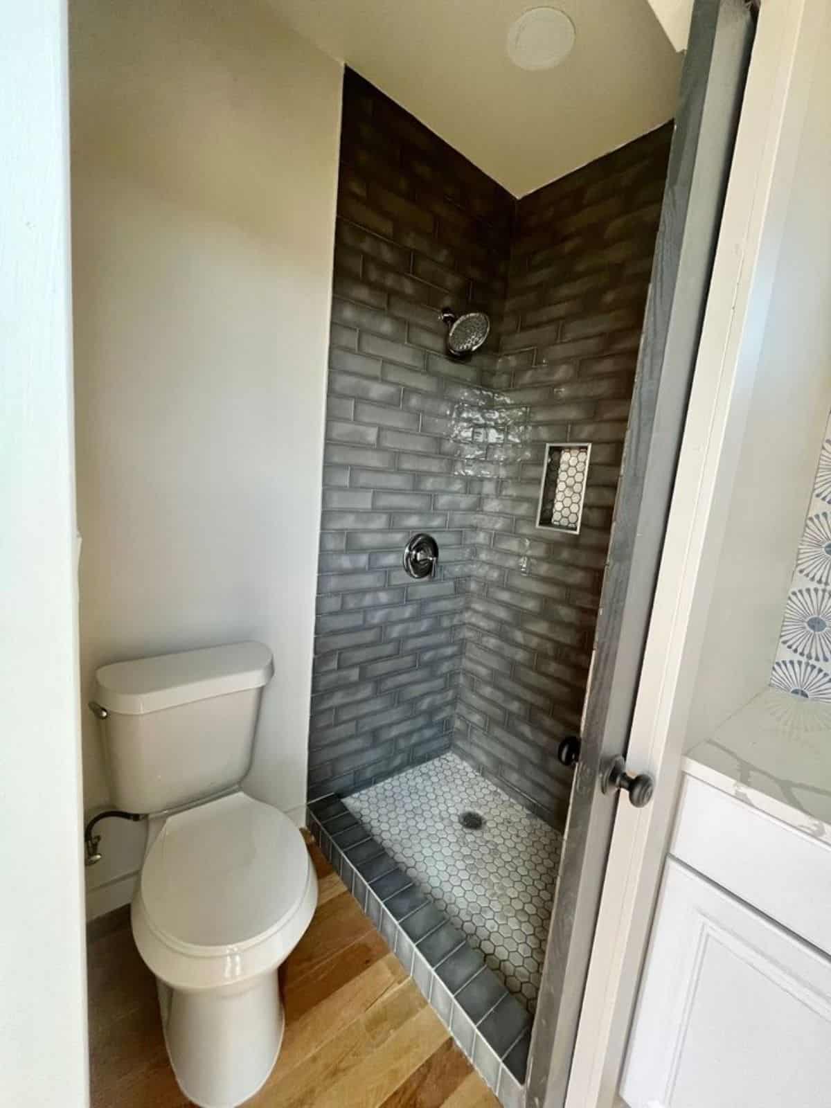 bathroom of tiny studio house has all the standard fittings
