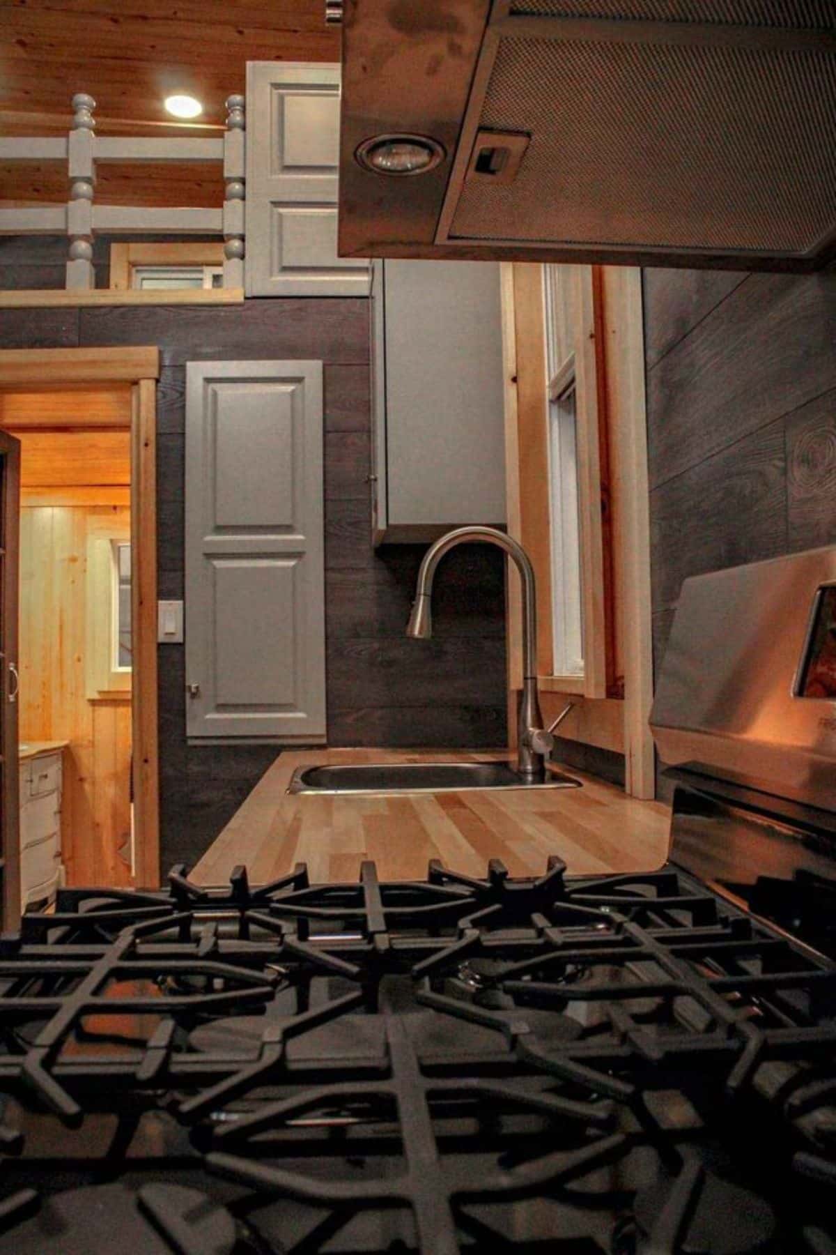 stove and sink with huge countertop in the kitchen area of beautiful tiny house