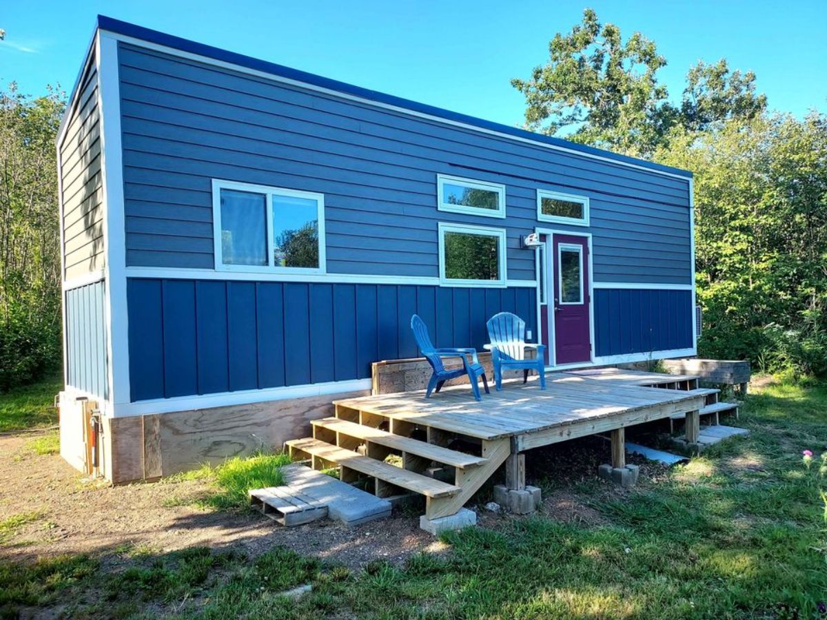 huge porch outside the main entrance with stunning exterior of tiny home in Minnesota