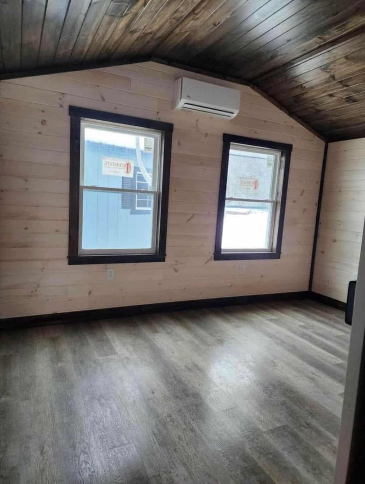 bedroom of spacious tiny home is very spacious with multiple window and split AC installed