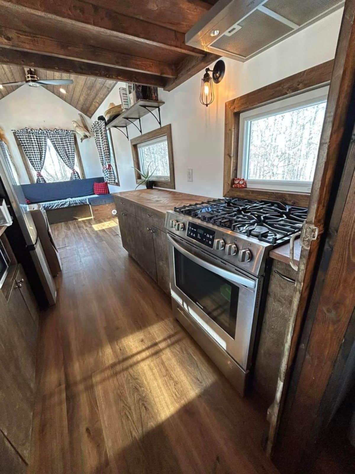 double galley kitchen area with long countertop, stove cum oven and storage cabinets on 1 side