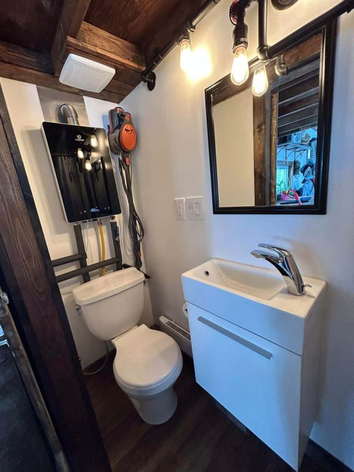 standard toilet and water heater installed in bathroom