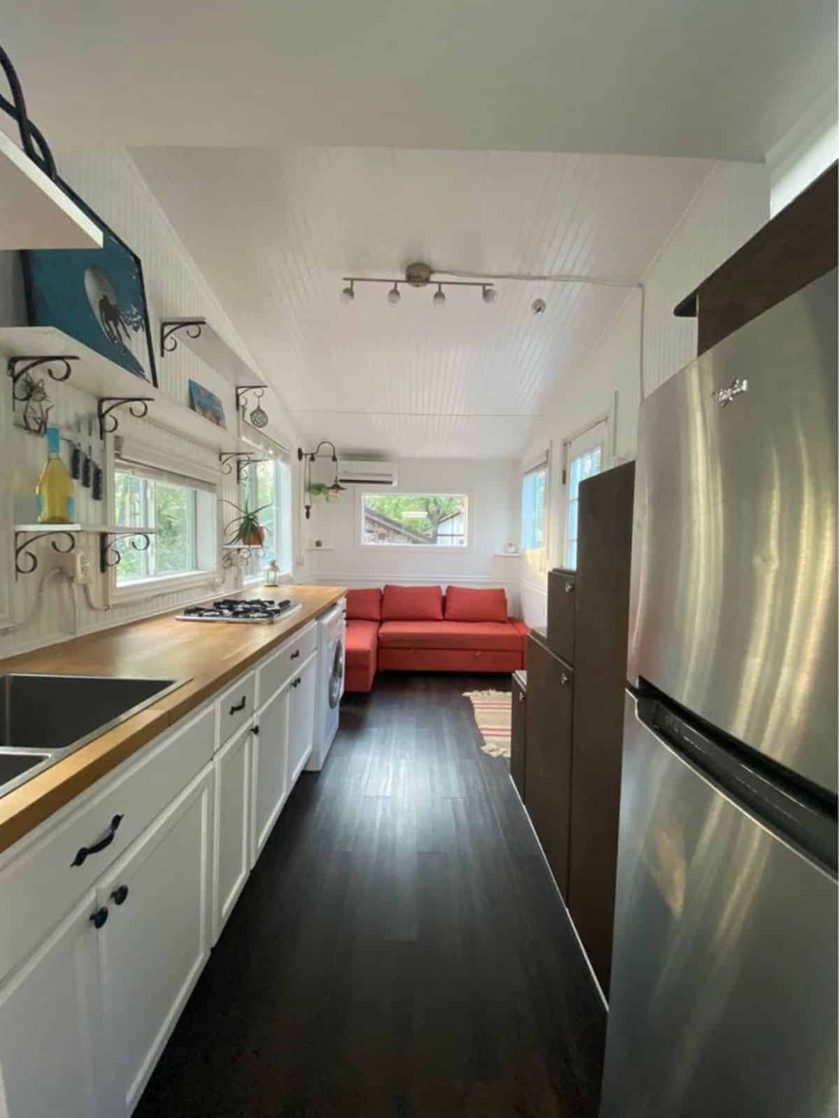 full length interiors of 20’ tiny home from kitchen point of view