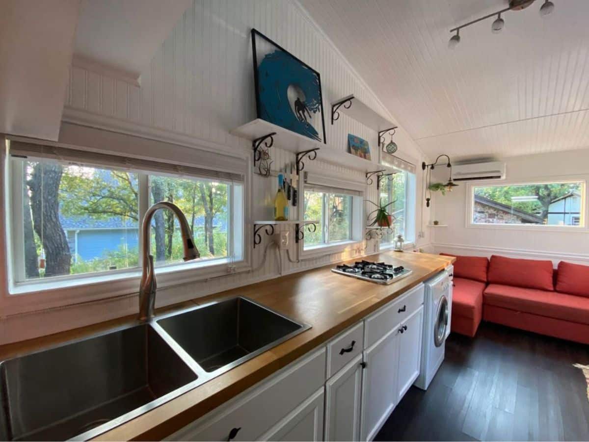 huge kitchen of 20’ tiny home has a countertop with sink and shelves