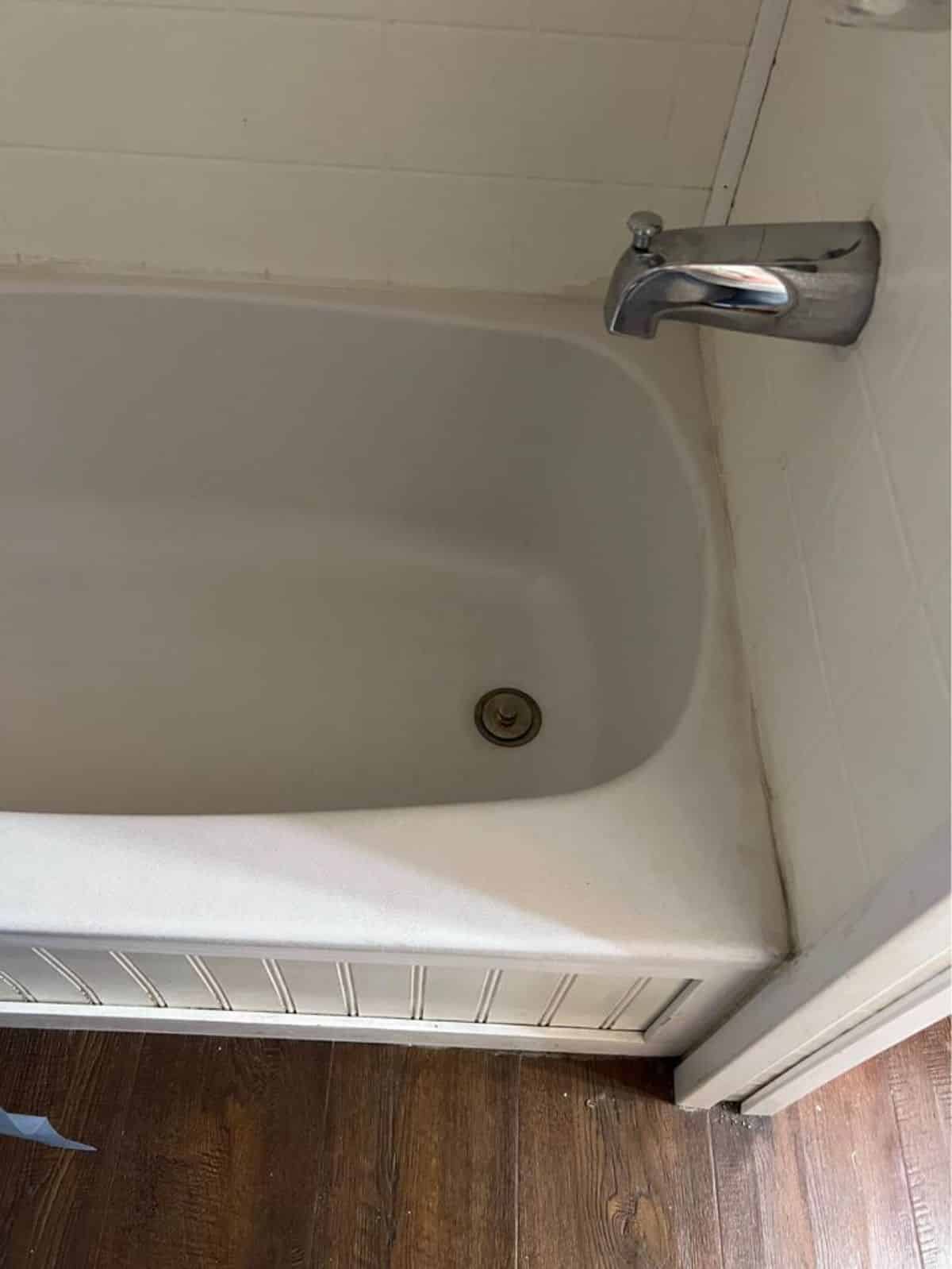 bathtub and shower in bathroom of 2 bedroom tiny house