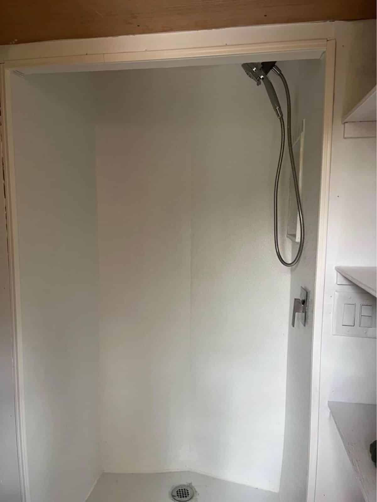 full length shower area with head shower in bathroom