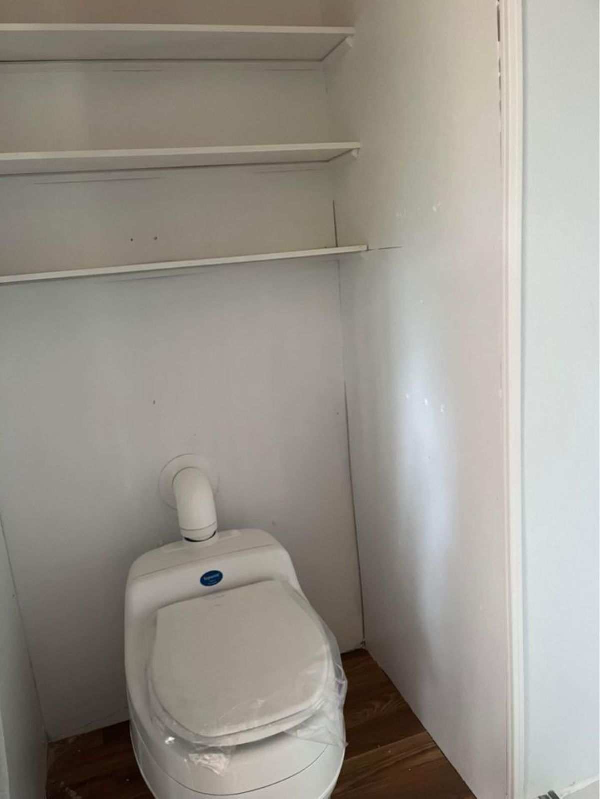 composting toilet in bathroom of fully insulated tiny home