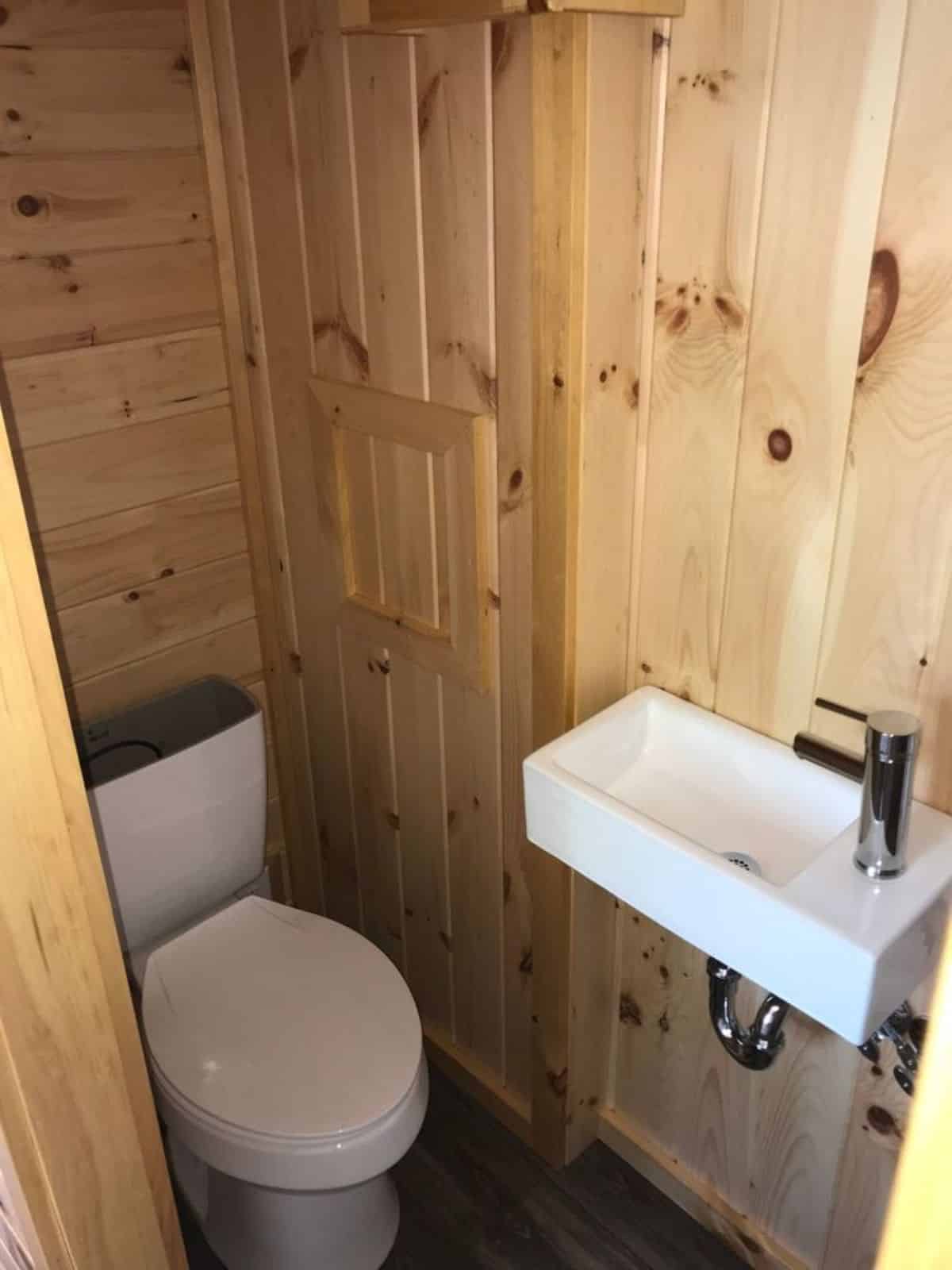 bathroom of two bedroom tiny home has all the standard fittings
