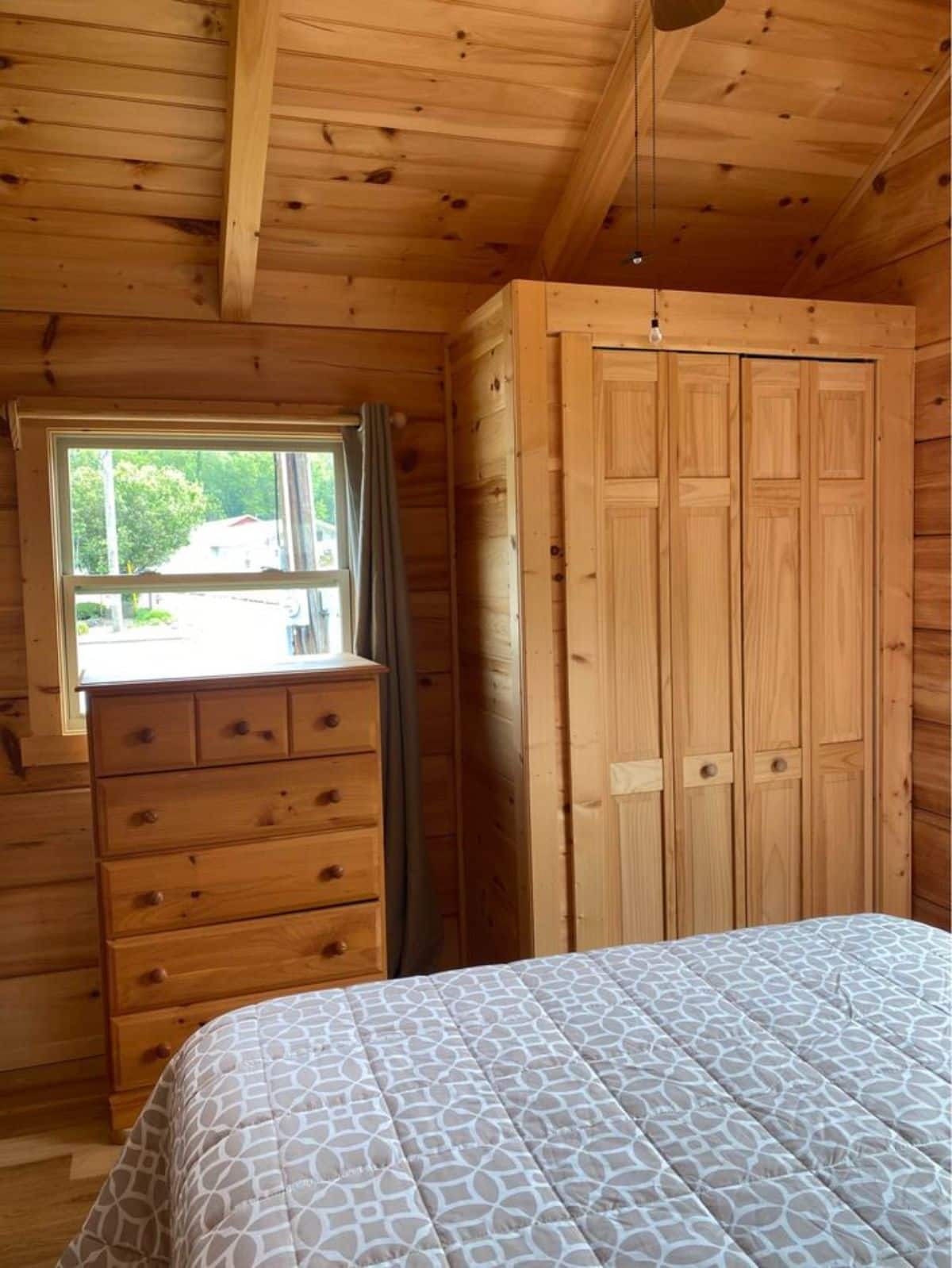 wardrobe and storage cabinets in the bedroom of custom built tiny home