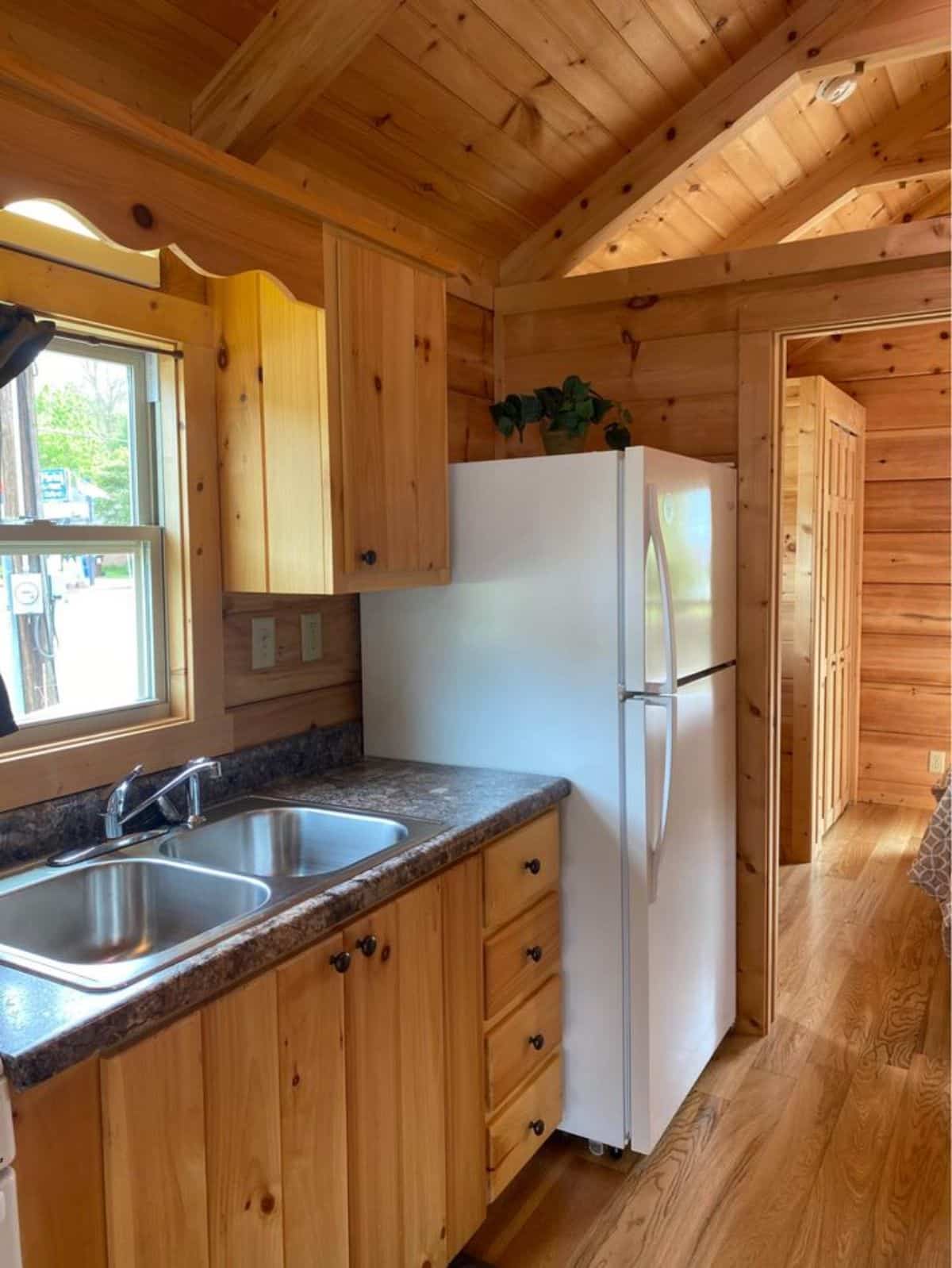 double door refrigerator in the kitchen area of custom built tiny home