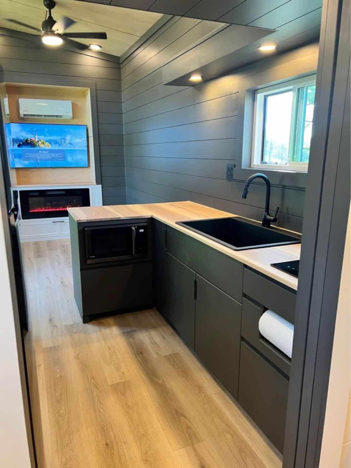 L shaped kitchen countertop in kitchen area of beautiful tiny home