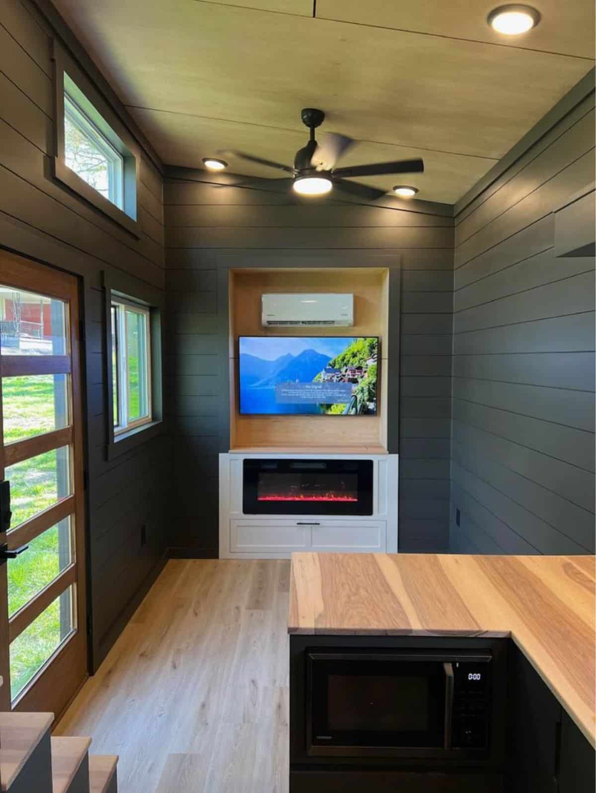 wall mounted TV and fireplace in the living area