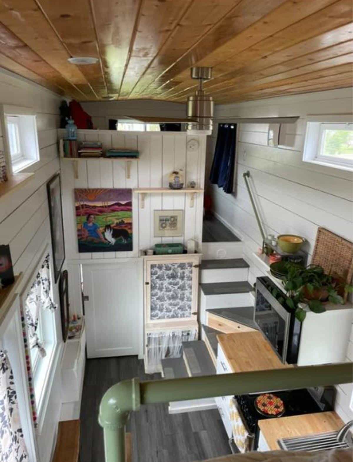 full length interiors of 24' tiny home on wheels from loft view