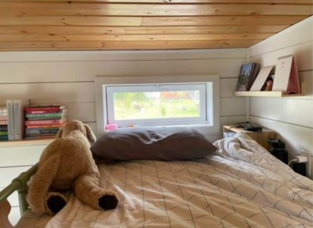 loft bedroom has a comfortable mattress with shelves