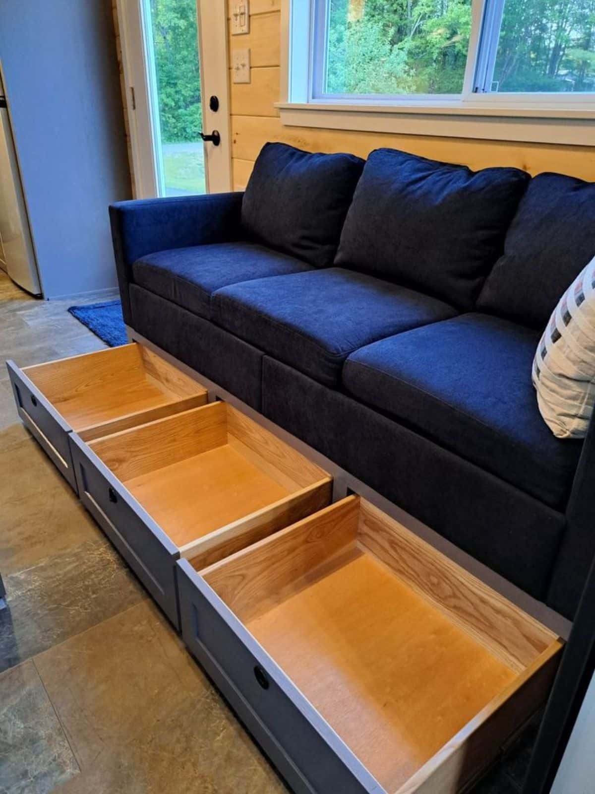 couch in living area has a storage underneath