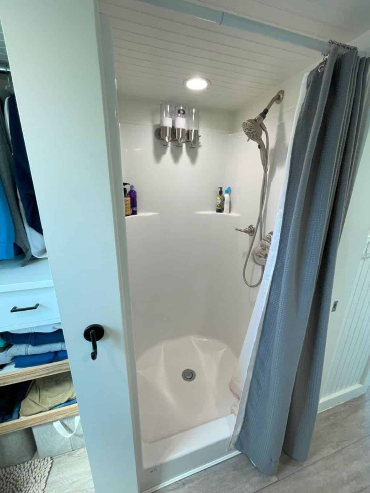 separate shower area with curtons in bathroom