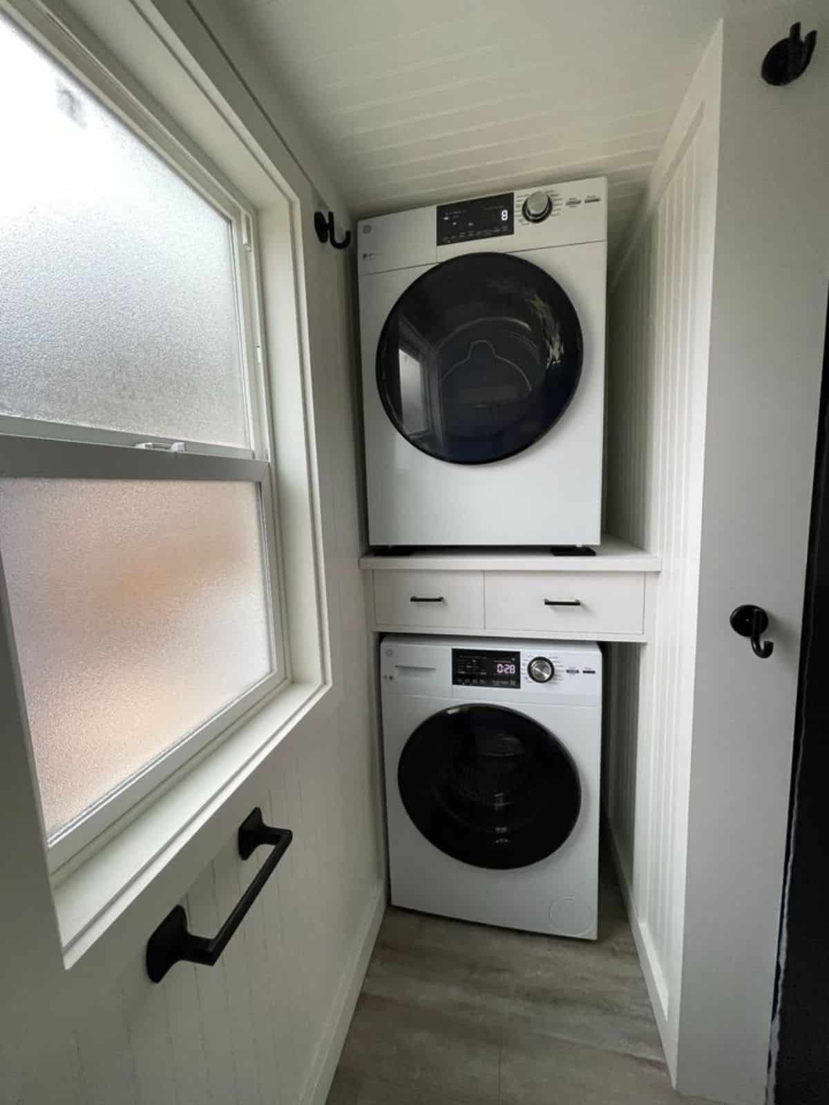 washer dryer combo in bathroom of 30’ two bedroom tiny home
