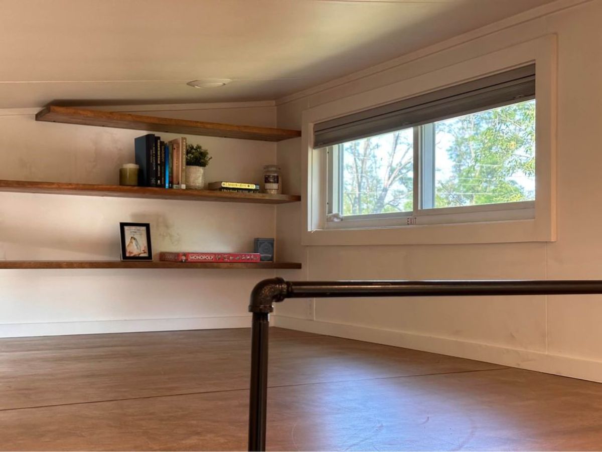 book shelves on the loft of 32' tiny home for four