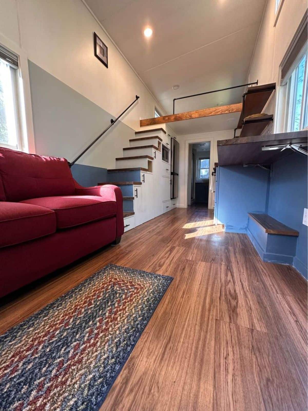 living area and stunning wooden flooring view of 32' tiny home for four