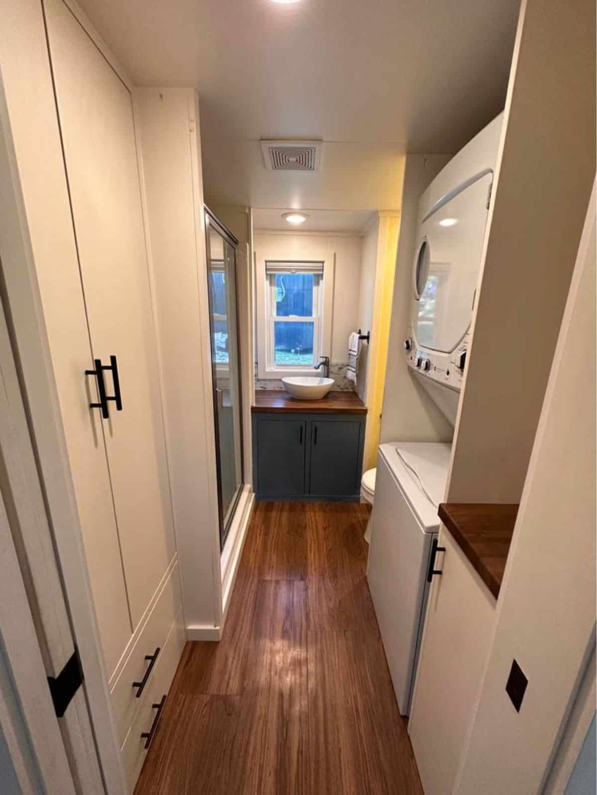 bathroom of 32' tiny home for four has all the standard fittings with washer dryer combo