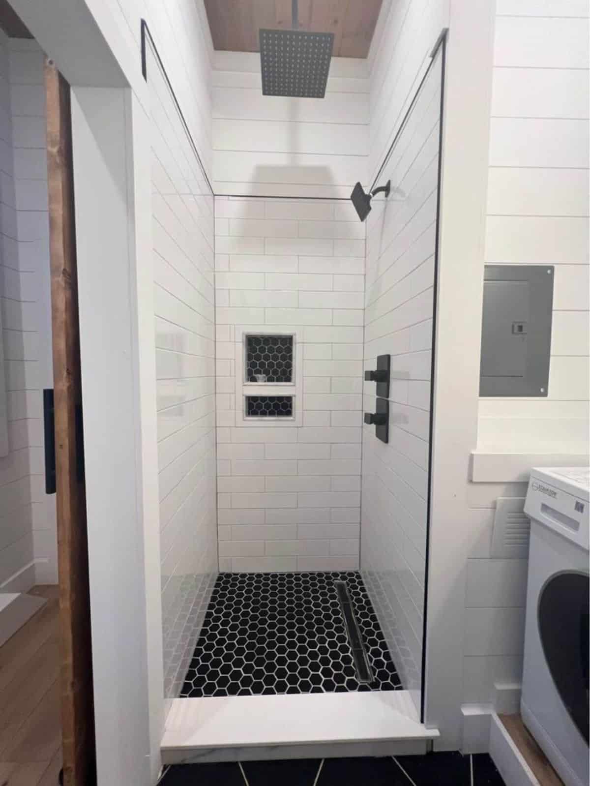 full length shower area with glass enclosure
