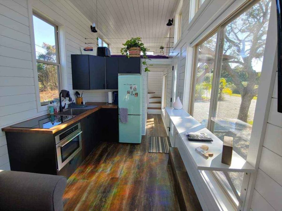 full length interiors and kitchen view of custom built tiny home