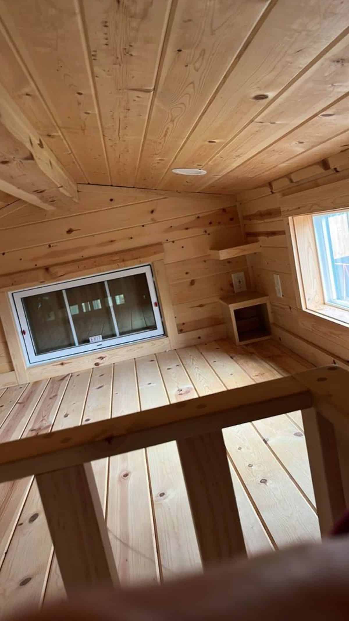 loft bedroom is spacious with multiple windows