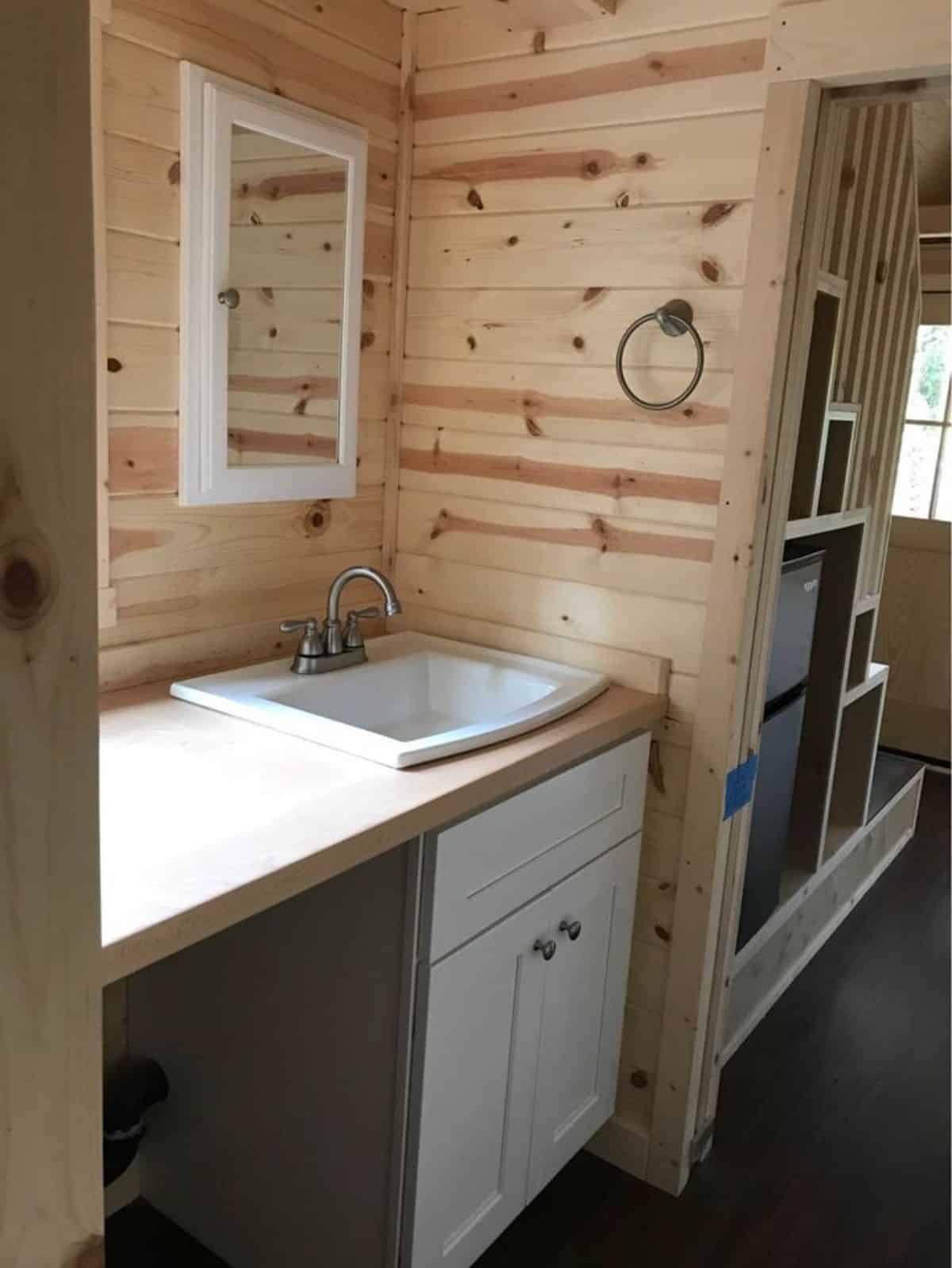 bathroom of rustic cabin house has all the standard fittings