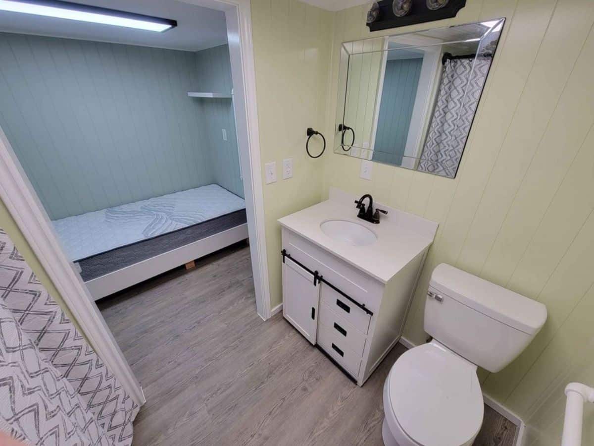 bathroom of immaculate tiny home has all the standard fittings