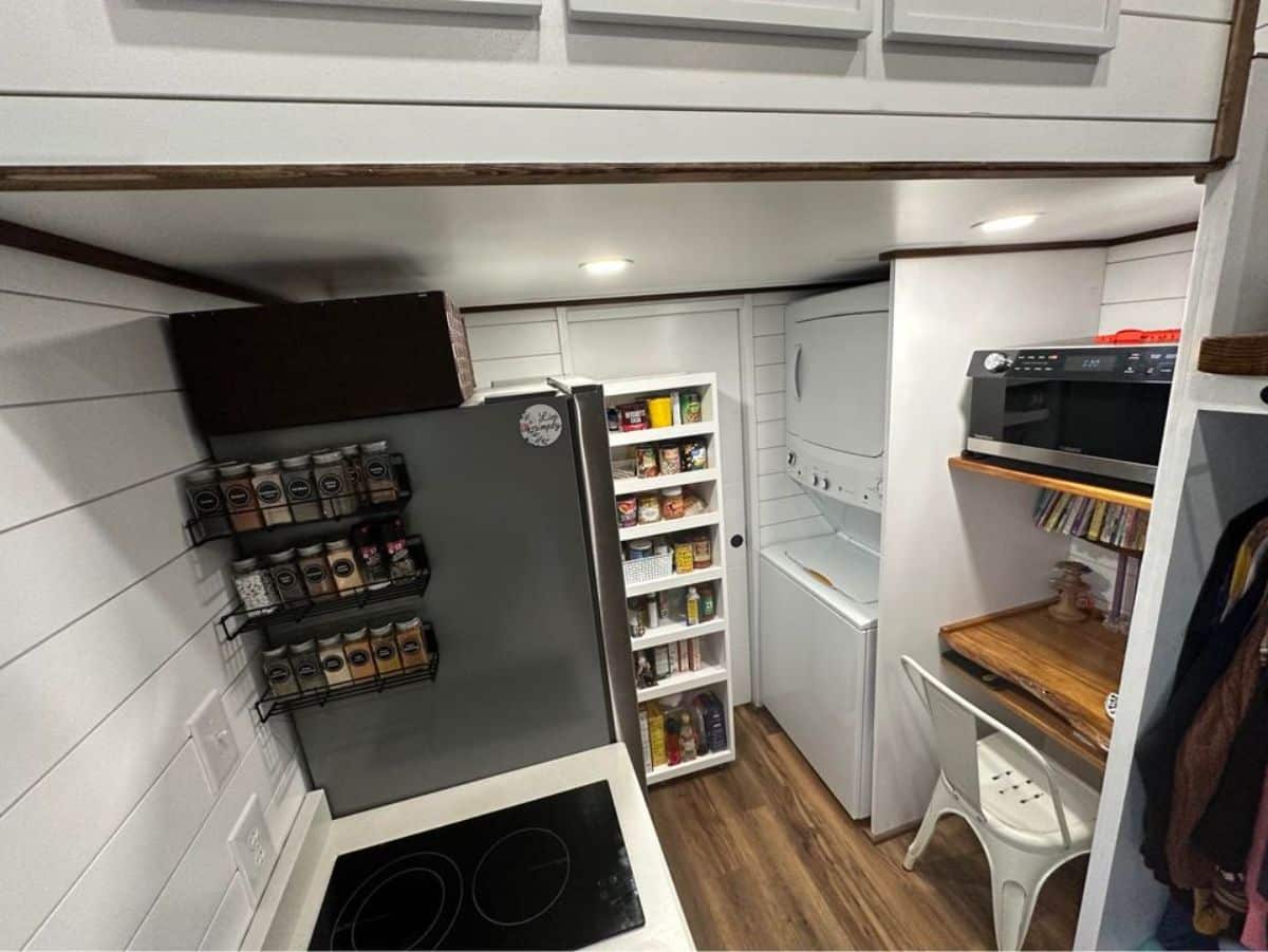 kitchen of 3 bedroom tiny house is well organized and neat with washer dryer combo