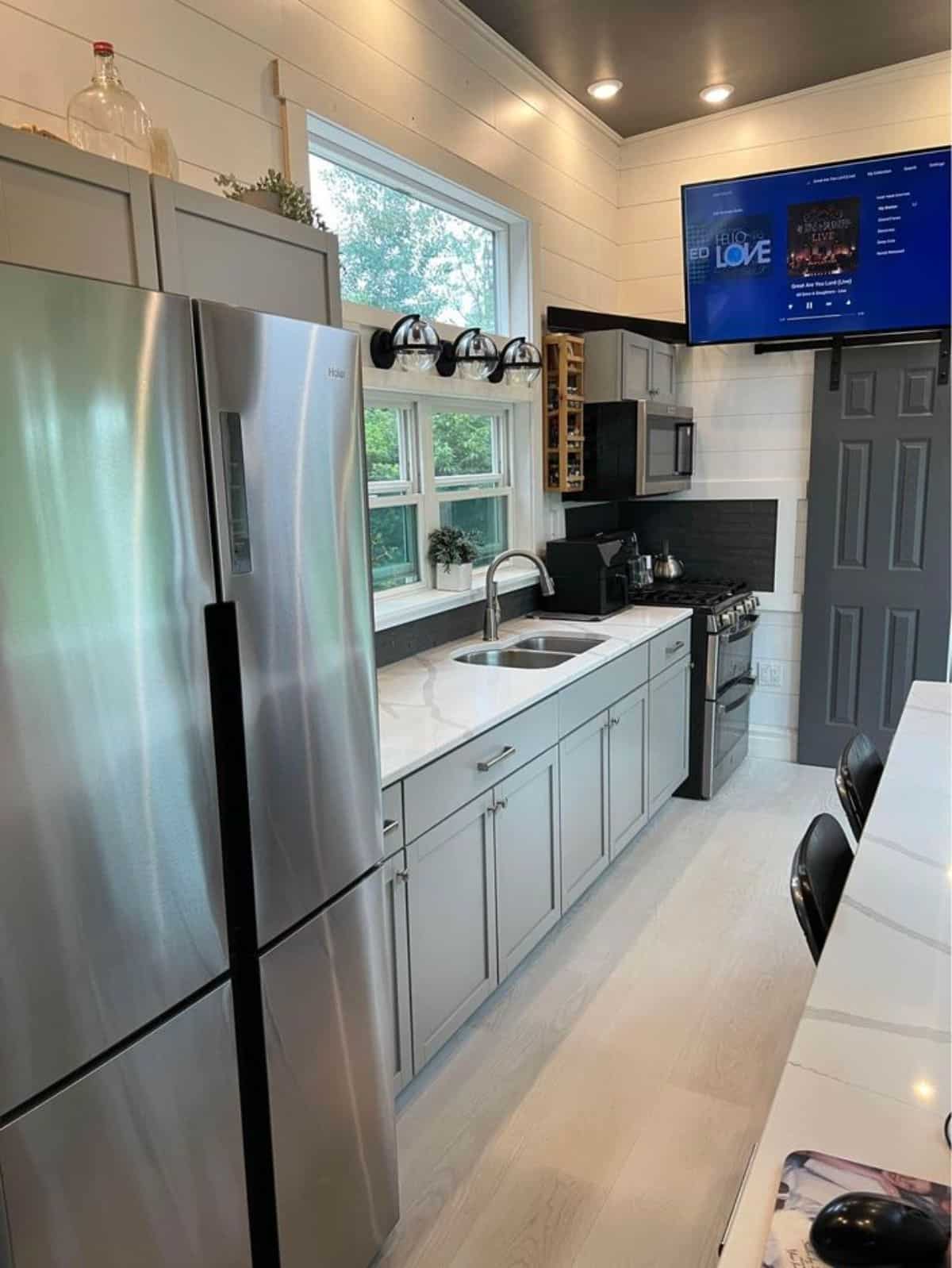 full length countertop with double door refrigerator in kitchen