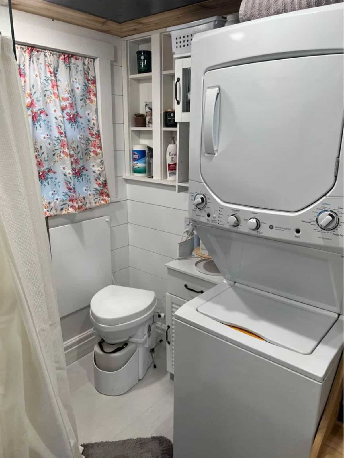 composting toilet , washer dryer combo in bathroom  of spacious tiny home