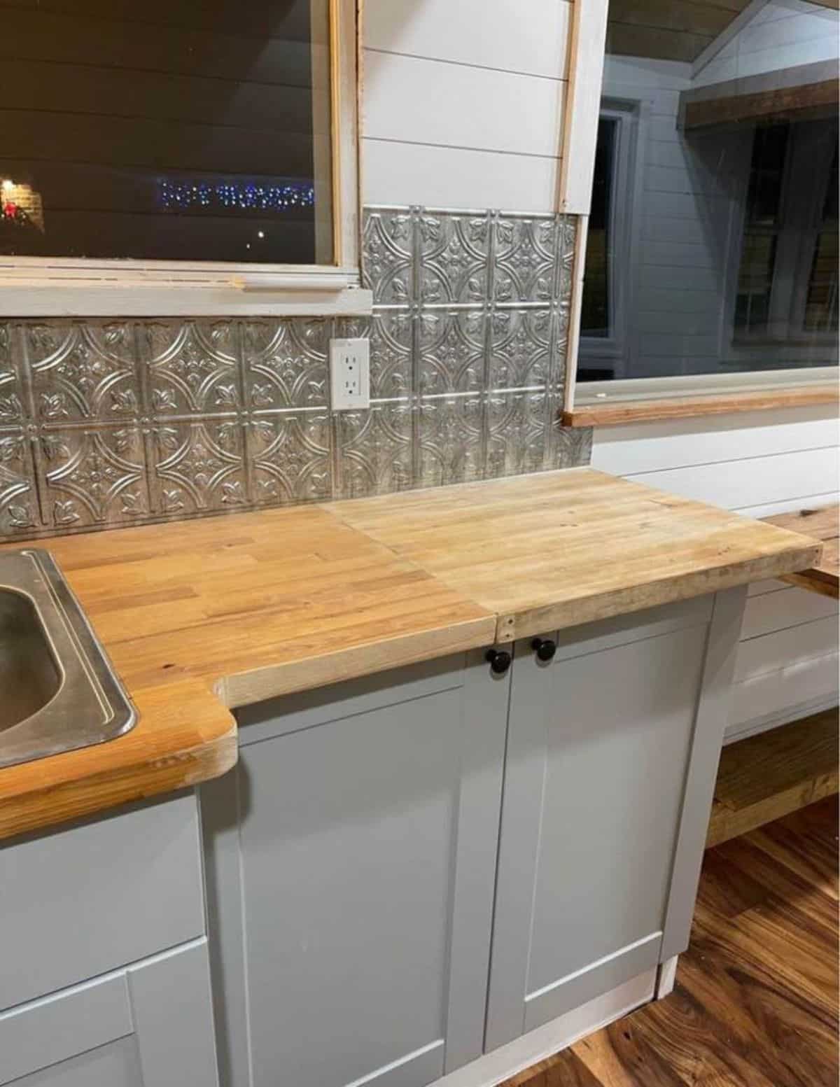 huge countertop with storage cabinets in the kitchen area