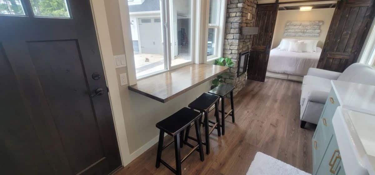 dining table with chairs besides the window