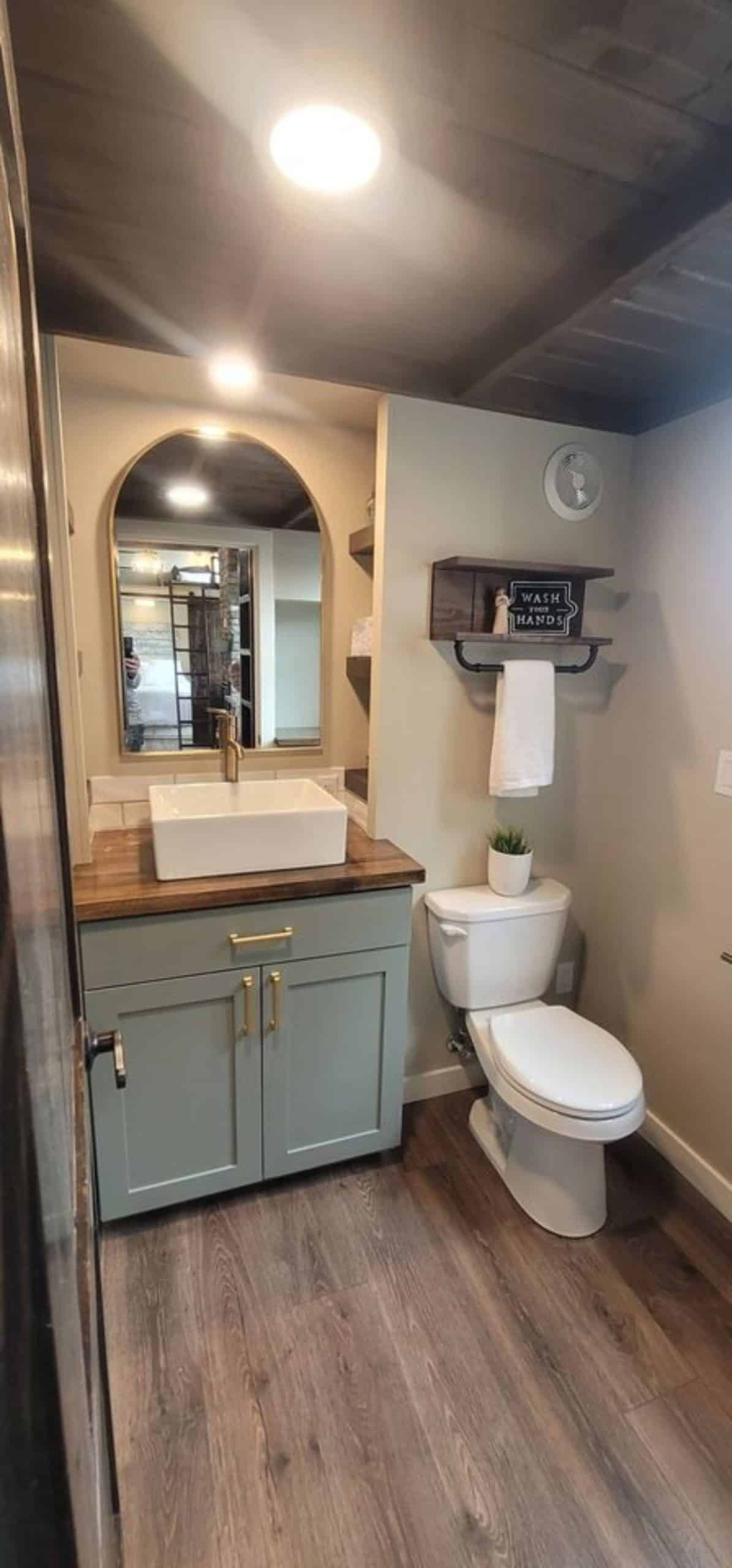 bathroom of 3 bedroom tiny house has all the standard fittings