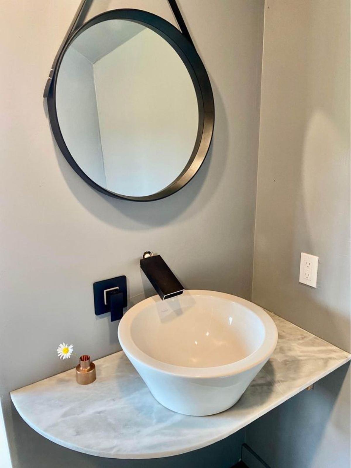 bathroom of stunning tiny home has a porcelain vessel sink 